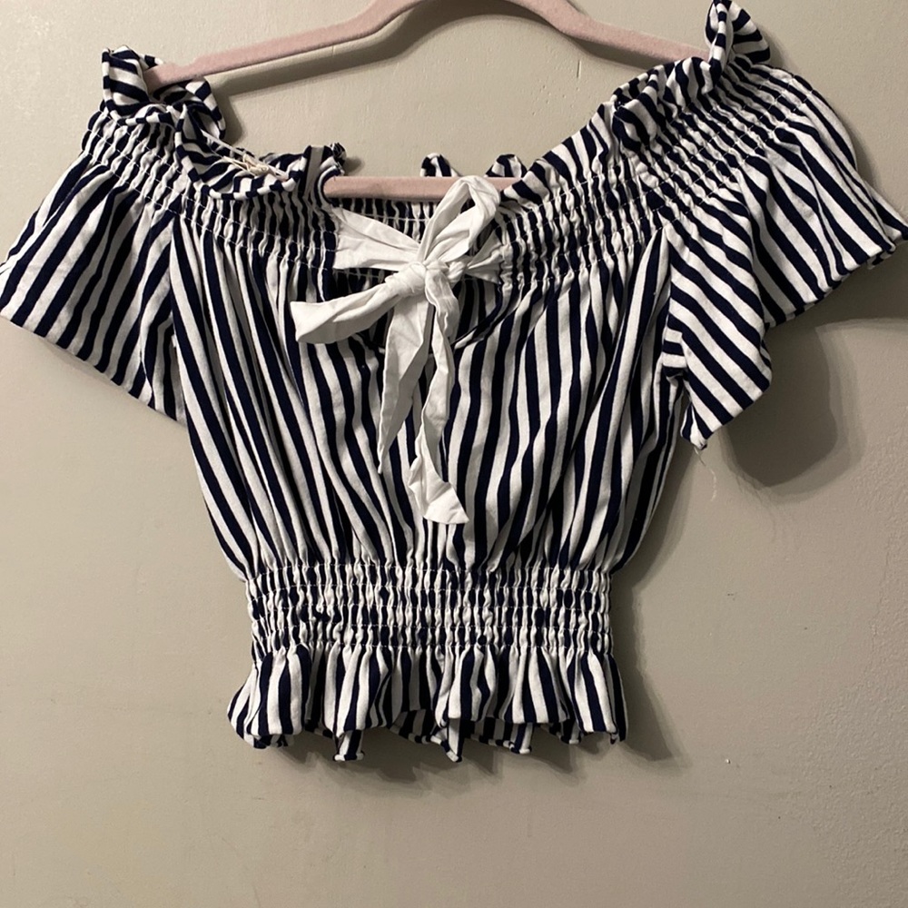 Small navy blue and white crop off the shoulder. Never worn before. Runs big